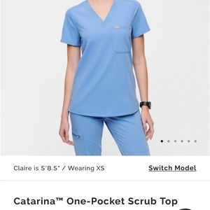 Caterina one pocket light blue size medium scrub top. Figs.